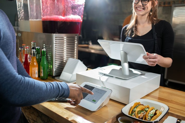 Person paying at a Clover Station Duo